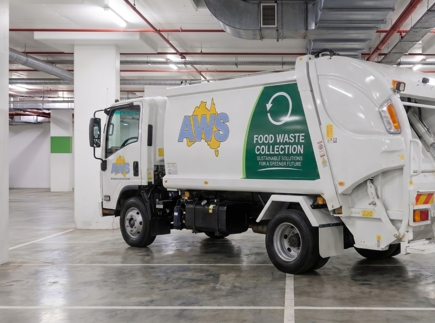 Australian Waste Services truck with Food Waste Collection livery, parked in an underground car park